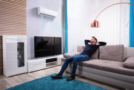 Man sitting in cool room with AC
